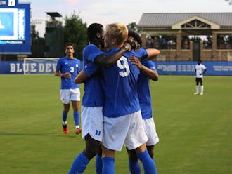 The Blue Devils, including Ulfur Bjornsson and Forster Ajago, embrace to celebrate Duke's 2-0 win against Virginia.