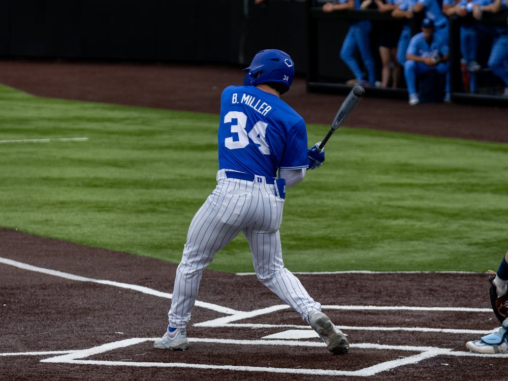 Graduate third baseman Ben Miller takes a swing for Duke baseball against North Carolina.