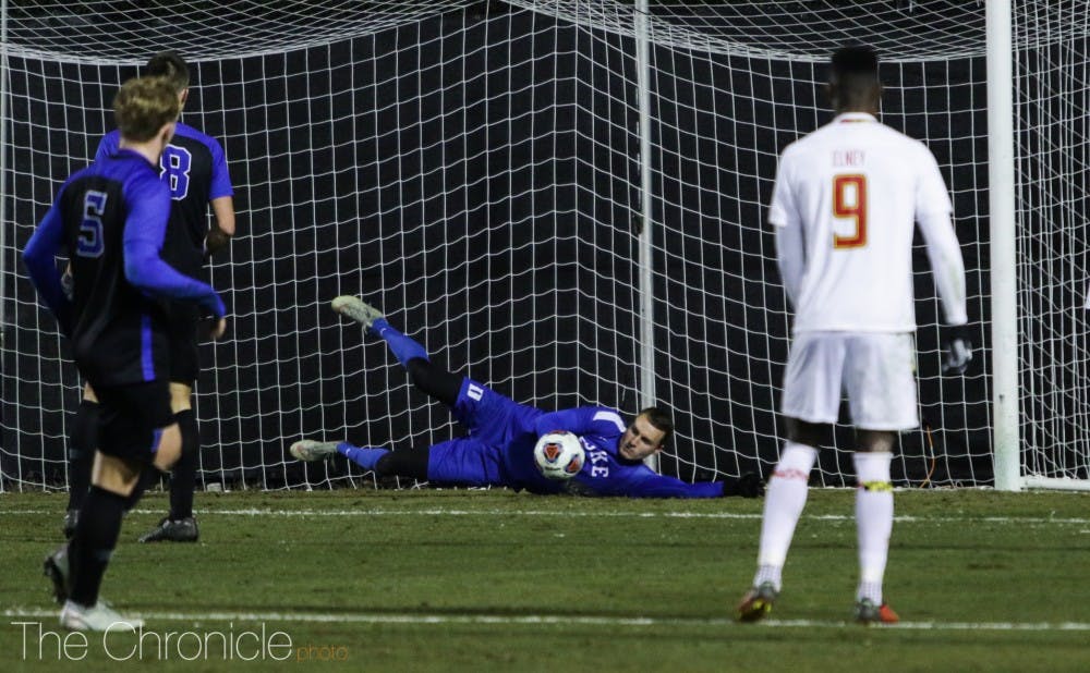 Goalkeeper Wil Pulisic scoops up one of Maryland's shots on goal. 