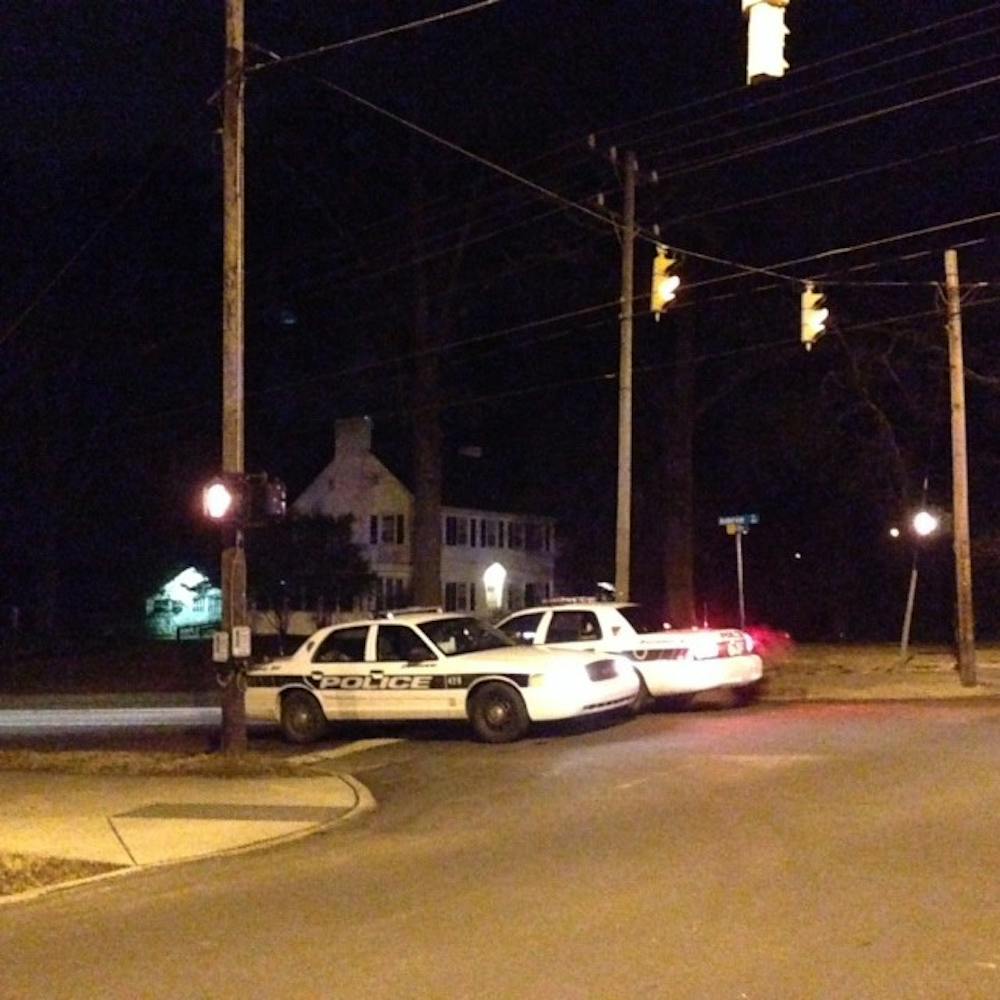 Two cop cars block off the entrance to Anderson Street from Campus Drive.