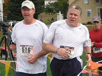 Jonathan Kuniholm, left, a retired captain in the U.S. Marine Corps, ran a half-marathon five years after losing his arm while on patrol in Iraq.