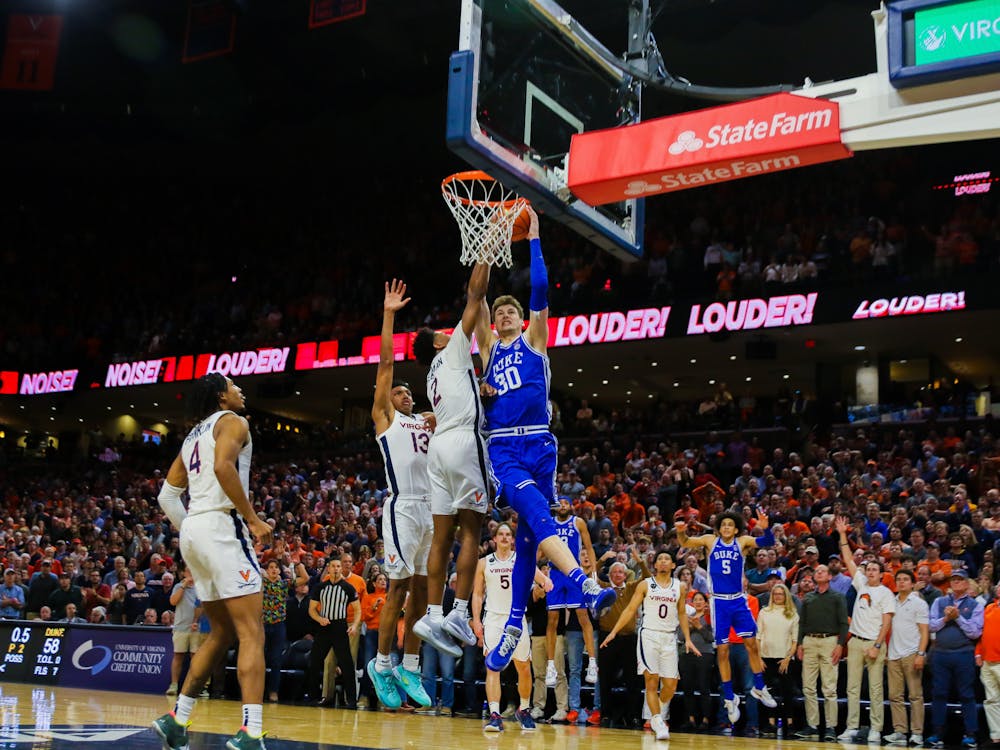 Duke freshman Kyle Filipowski drives to the basket on the final play of regulation. A foul called against Reece Beekman was overturned after review.