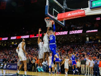 Duke freshman Kyle Filipowski drives to the basket on the final play of regulation. A foul called against Reece Beekman was overturned after review.