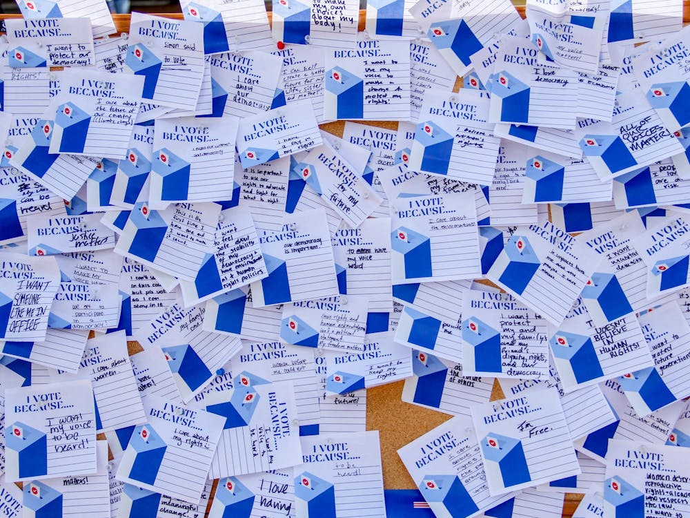 Duke students posted reasons for voting at a booth on the East Campus bus stop.