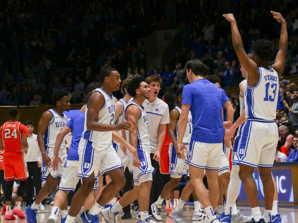 Duke men's basketball celebrates in a timeout in its game against Syracuse.