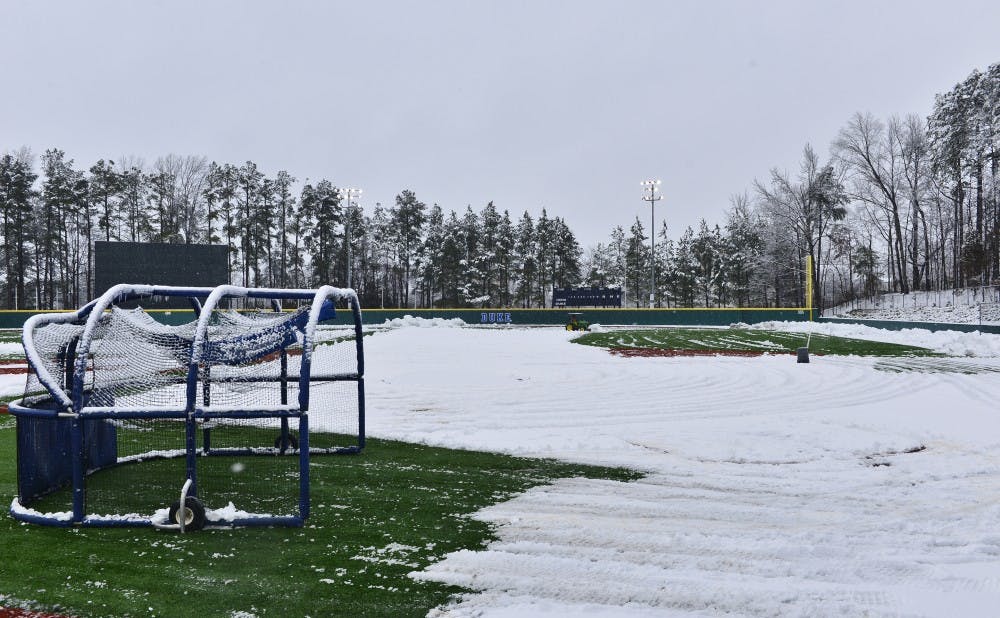 Duke's grounds crew started plowing snow off the field at Jack Coombs Stadium 8:30 Friday morning in preparation for the Blue Devils' delayed three-game homestand.