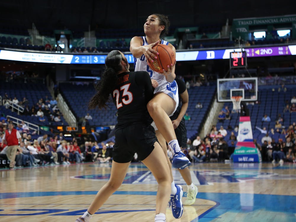 Duke's Taya Corosdale attempts to drive around Virginia Tech's Kayana Traylor in Saturday's ACC semifinal matchup. 