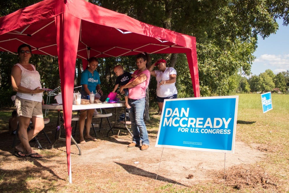 Alicia Jacobs, far right, and her family campaigned for McCready outside an early voting site in Pembroke. 