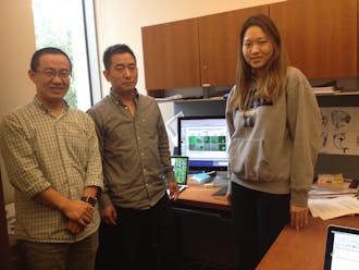 The lab of engineering professor Lingchong You (middle) has developed a method for producing "swarmbots," an engineered bacterial strain&nbsp;that dies outside of its colony.