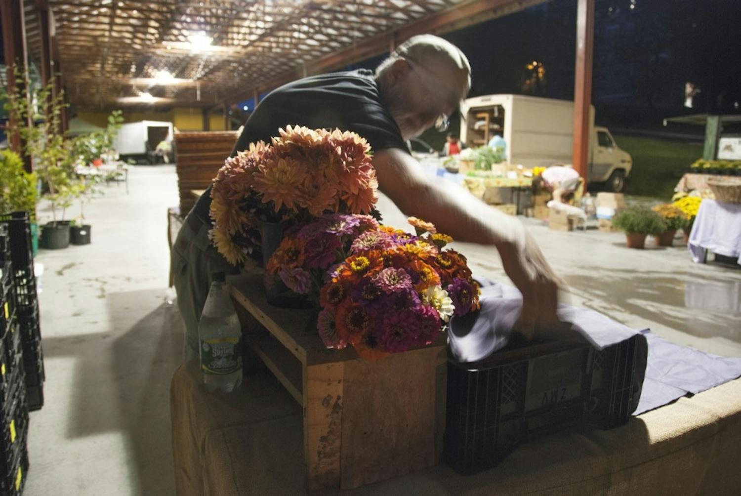 Vendors arrive at the Durham Central Park market before sunrise to set up their stands and arrange produce. For Helga and Tim, each Saturday morning consists of a precisely articulated set-up routine in preparation for their many customers.