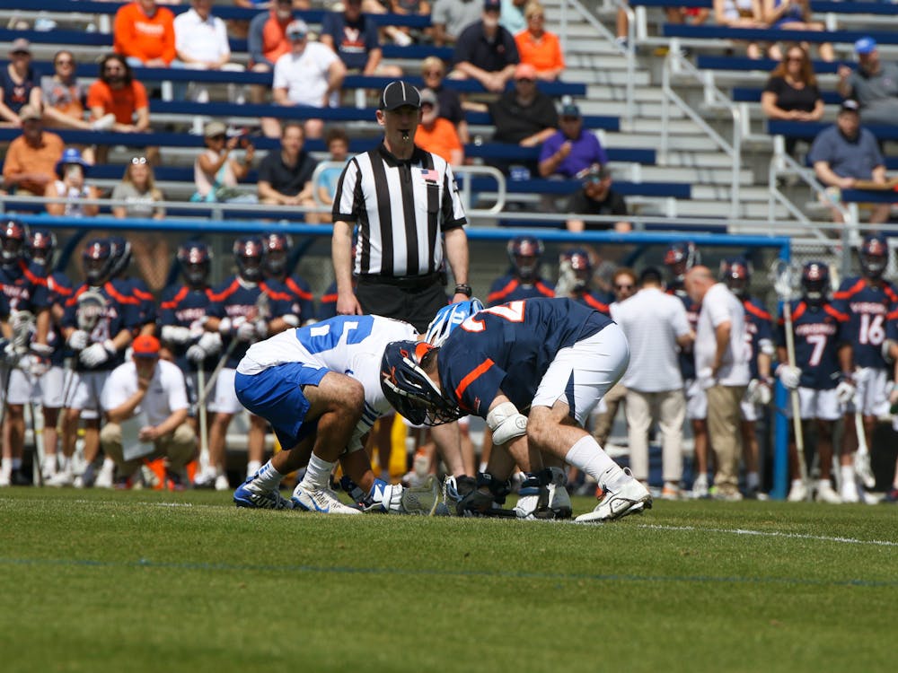 <p>Duke's Jake Naso and Virginia's Petey LaSalla compete for the faceoff. Naso won the matchup at the X for the first time against the Cavalier star.</p>