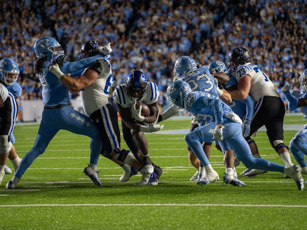 Running back Jordan Waters powers through North Carolina's defensive line in the first half of Saturday's contest.
