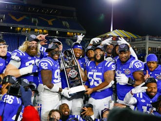 Duke celebrates with the newest addition to its trophy room after defeating UCF in the Military Bowl.