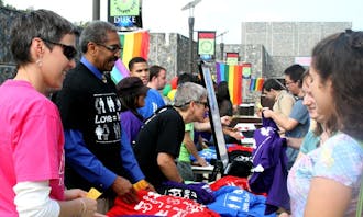Students pick up “Love=Love” T-shirts  on the West Campus Plaza for Coming Out Day at Duke Friday. The National Coming Out Day was Sunday.