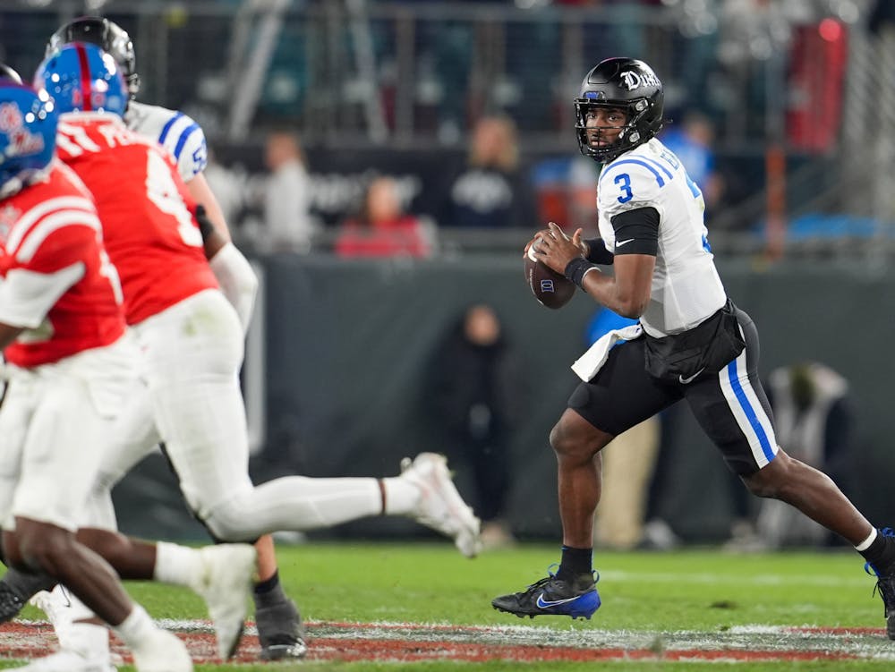 <p>Henry Belin IV rolls to the right against Ole Miss.&nbsp;</p>