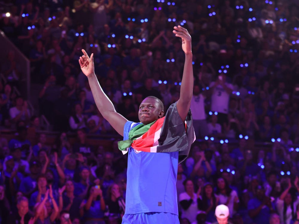 Khaman Maluach wears a South Sudanese flag at Countdown to Craziness. 