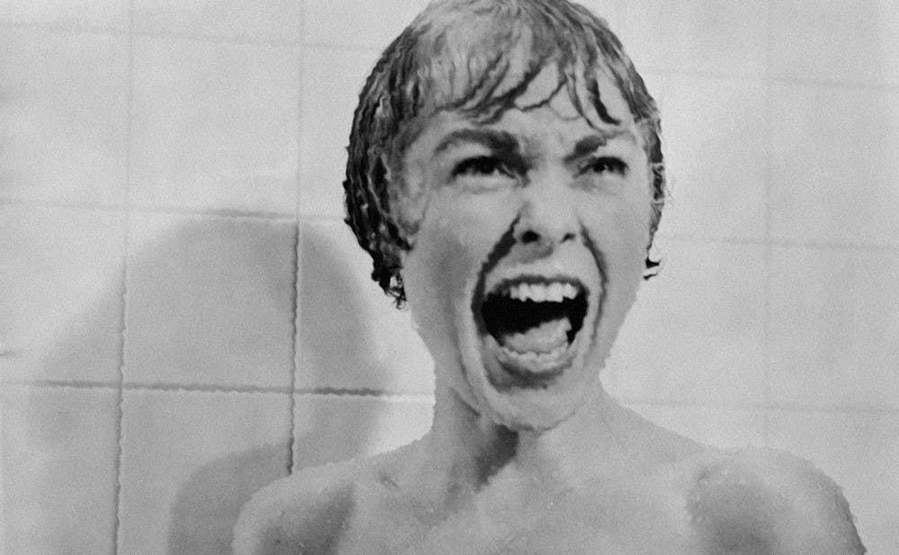 Marion Crane screams in terror as Norman Bates rips open her shower curtain.