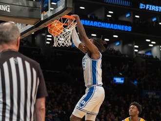 Mark Mitchell slams the ball home during the first half of Duke's matchup with Vermont.