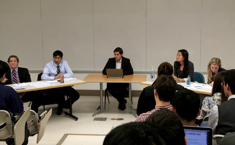 Editorial pages editor Scott Briggs moderated a debate between (pictured left to right) seniors Daniel Strunk and Ajeet Hansra versus junior Joyce Lau and senior Stefani Jones.