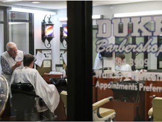 The Duke Barbershop in May, as longtime manager David Fowler cuts a customer's hair.