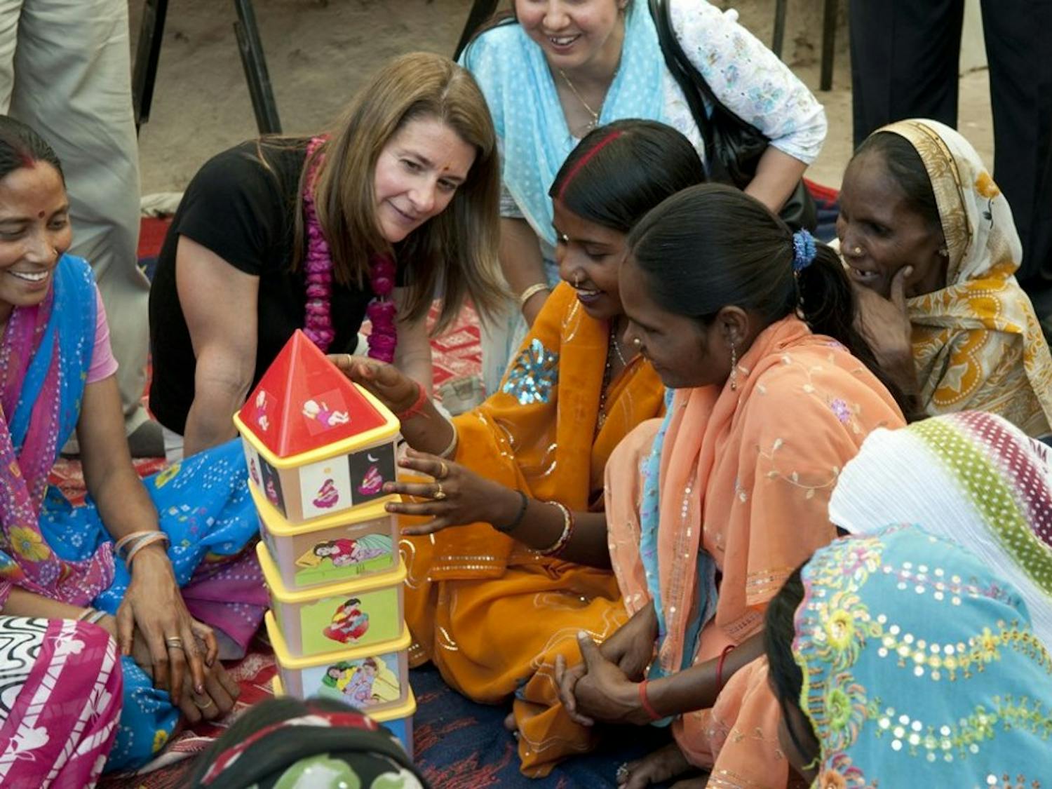 Melinda French Gates and participants at a Sure Start Project initiative to promote maternal and newborn health in Kathghara Village, Fatehpur District, U.P., India on March 23, 2010. The women are playing a stacking game to promote family wellness.