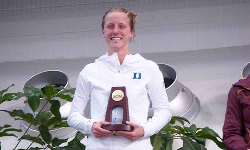 Abby Johnston poses with her national championship trophy after winning the three-meter jump Friday.