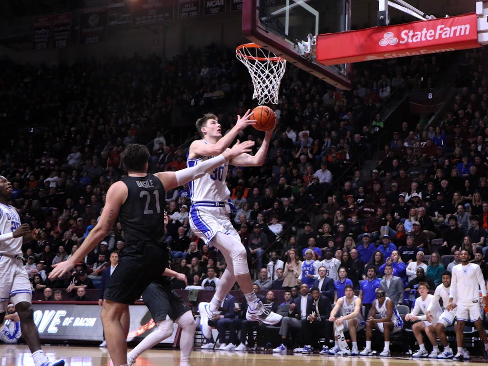 Kyle Filipowski drives for two of his career-high 29 points in Duke's loss at Virginia Tech. 