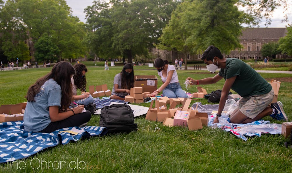 Campus students decided to use their beautiful spring days to make care packages together for Duke students to use during finals. "While we made these packages to help others feel cared for, I found the act of making the packages in the sun on the quad therapeutic in and of itself. I haven't been able to feel this way for a while, especially with the spring I lost last year," said Hindu Students Association co-president Sarabesh Natarajan.