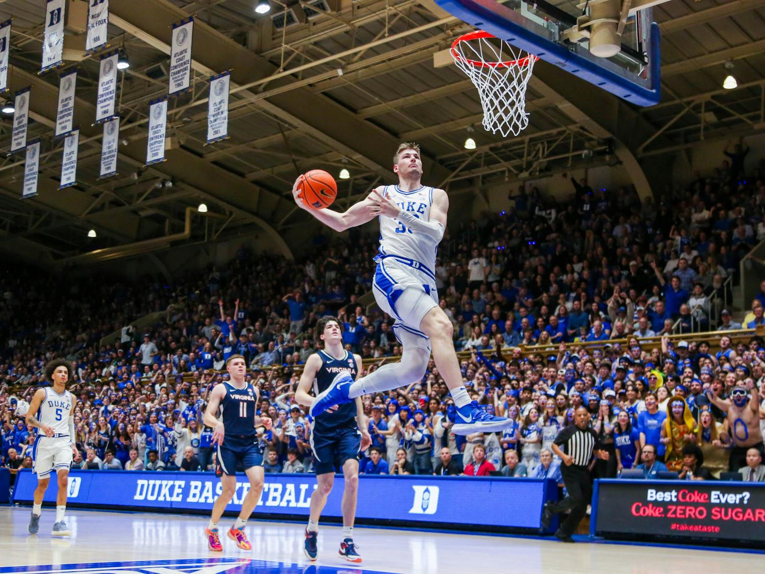 Sophomore center Kyle Filipowski goes up for the windmill dunk in Duke's March 2 win against Virginia.