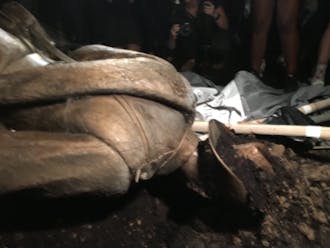 The Silent Sam Statue was topped by protesters Monday night. This is the statue a few minutes after it was overturned. | Courtesy of Mike Ogle