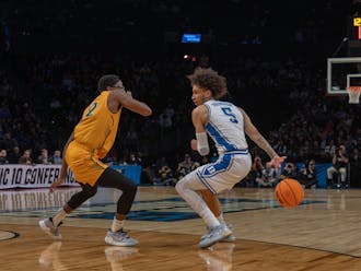 Tyrese Proctor switches the ball behind his back during Duke's win against Vermont.