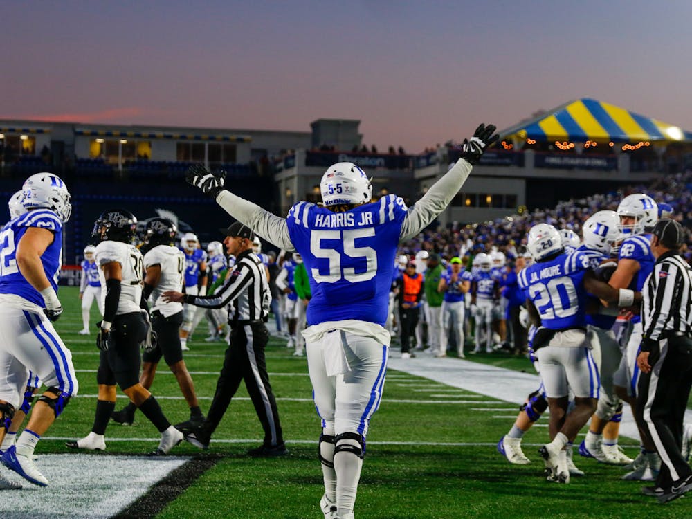 Graduate offensive lineman Andre Harris Jr. throws his hands in the air as the Blue Devils' celebration begins.