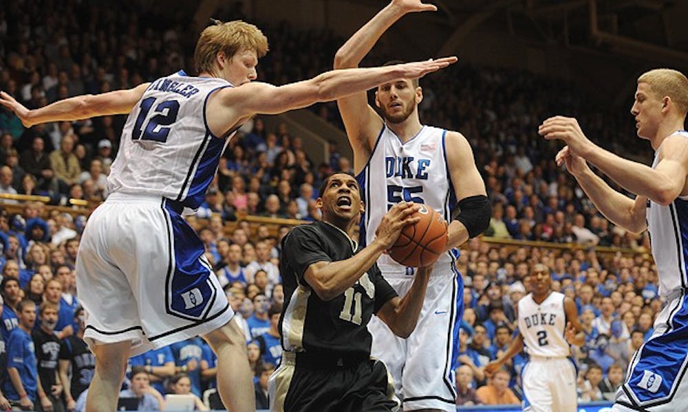 Wake Forest guard C.J. Harris found himself surrounded by three very tall Blue Devils Sunday evening, and so did many of his Demon Deacon teammates in a rough game that  resulted in 47 foul calls and countless tussles under the basket.