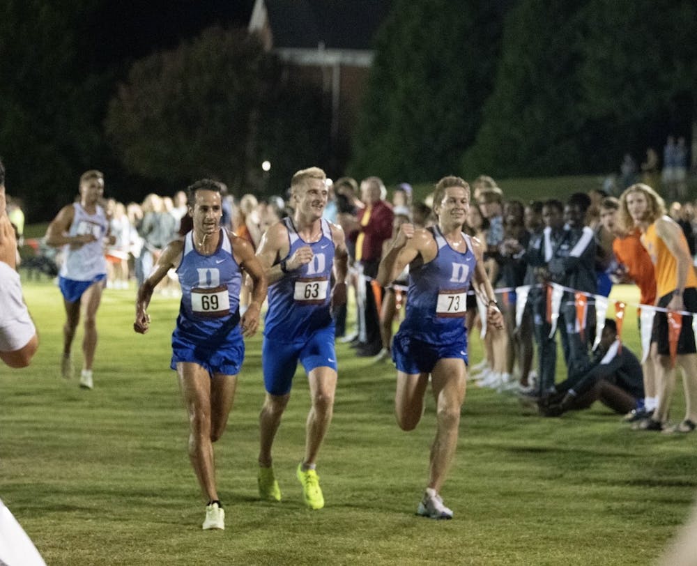 From left: Austin Gabay, Rory Cavan and Jared Kreis cross the finish line together at the Elon Opener.