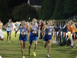 From left: Austin Gabay, Rory Cavan and Jared Kreis cross the finish line together at the Elon Opener.