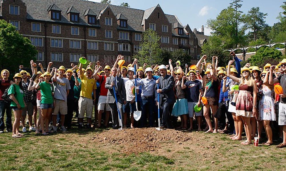 President Richard Brodhead (left) and Steve Nowicki (front row, right), dean and vice provost for undergraduate education, break ground on the K4 residence hall Friday. The building, which would complete the Keohane Quadrangle, marks the beginning of a new housing model for Duke.
