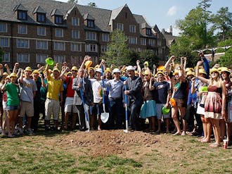 President Richard Brodhead (left) and Steve Nowicki (front row, right), dean and vice provost for undergraduate education, break ground on the K4 residence hall Friday. The building, which would complete the Keohane Quadrangle, marks the beginning of a new housing model for Duke.