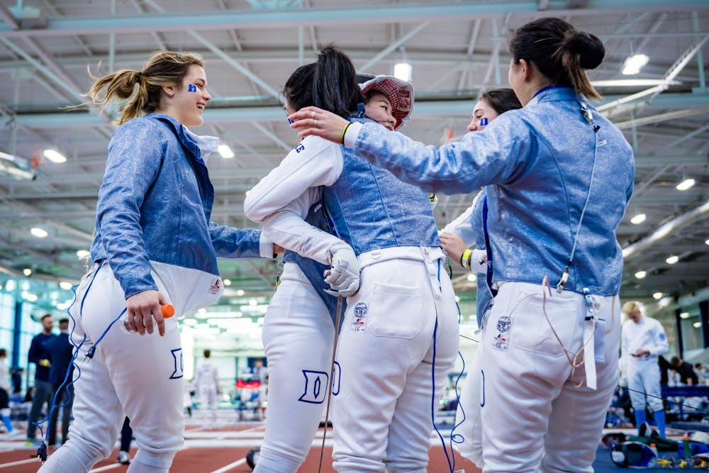 Duke fencers celebrate at the Penn State Duals in January 2023.