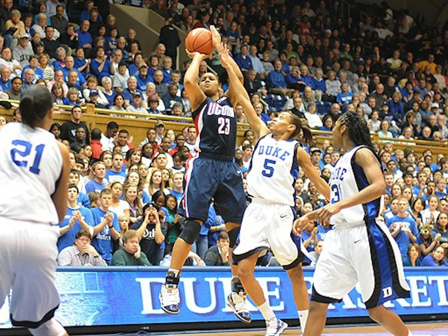 Connecticut forward Maya Moore scored a quiet 20 points, most of them from the perimeter, to help kill any Duke hopes Monday.