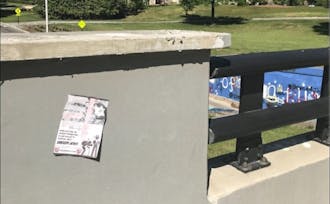 One of the posters was found taped to the wall, while the other was found upside down on the sidewalk.