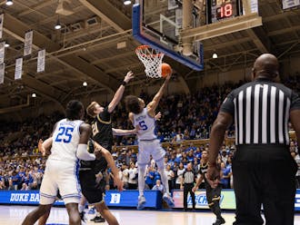 Tyrese Proctor (5) lays the ball in under the basket during Duke's win against La Salle.
