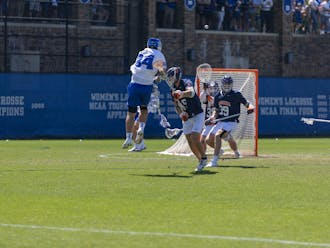 Senior attack Brennan O'Neill fires a shot for Duke men's lacrosse against Virginia.