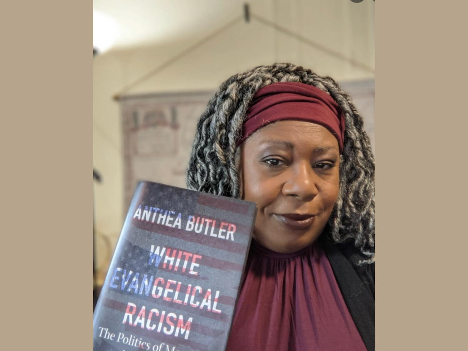 Anthea Butler with her book, “White Evangelical Racism: The Politics of Morality in America.”