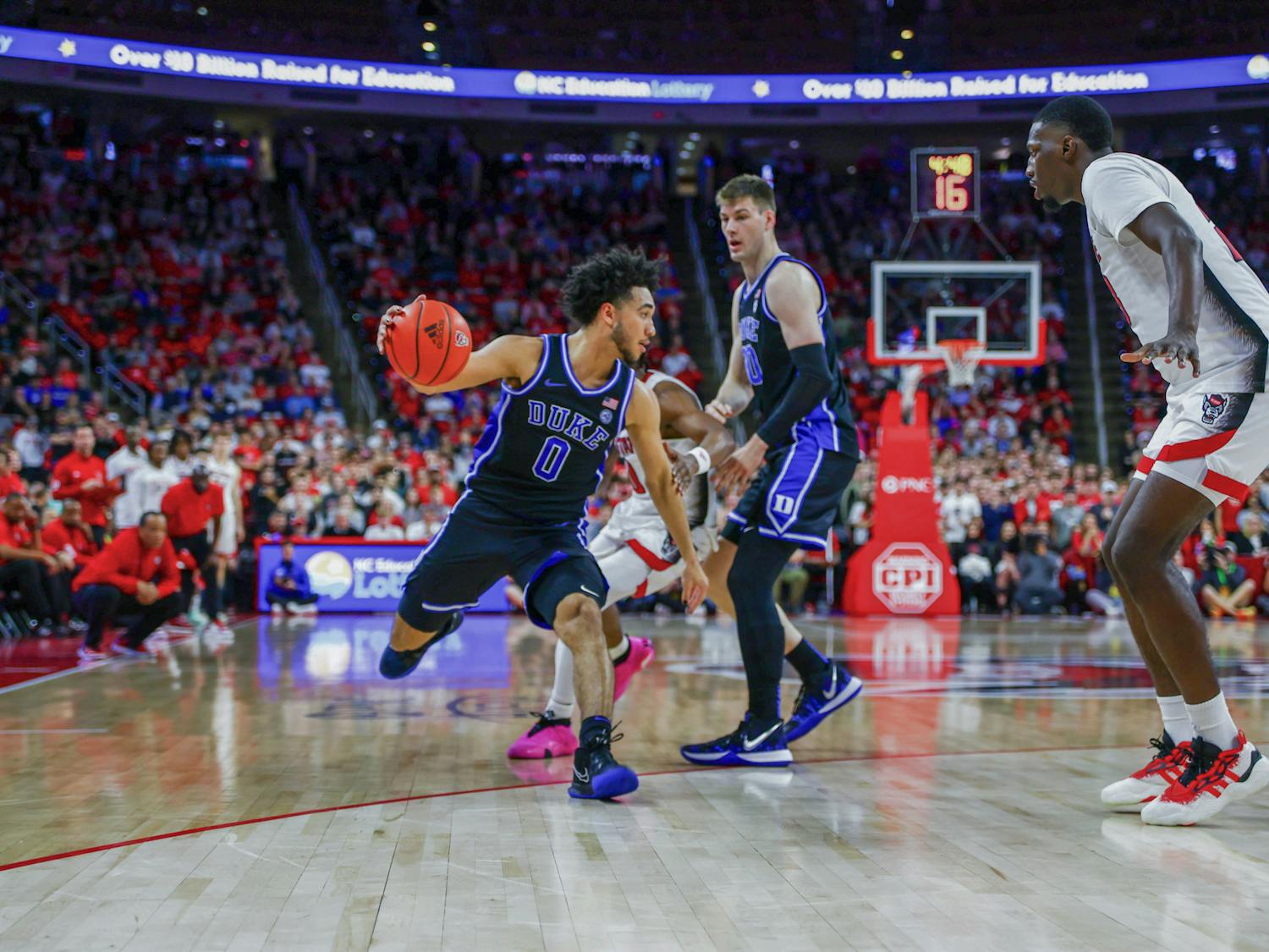 Jared McCain drives with the ball as Kyle Filipowski sets a screen during Duke's regular-season matchup with N.C. State.