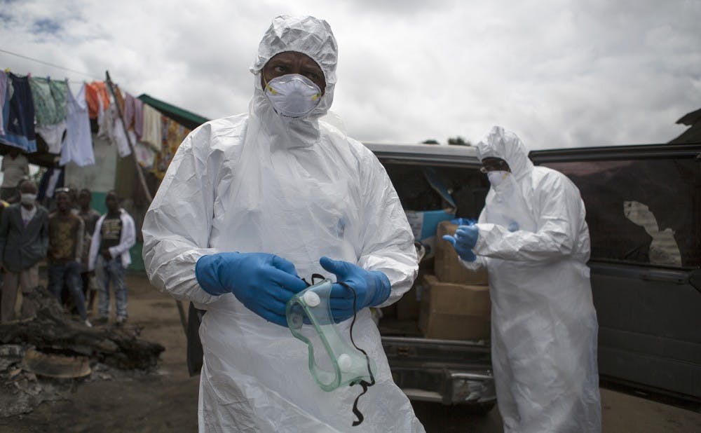 An ambulance team prepares to collect a body suspected of being infected with Ebola by putting on protective equipment on October 14, 2014 in Monrovia, Liberia. Illustrates EBOLA-AMBULANCE (category i), by Kevin Sieff (c) 2014, The Washington Post. Moved Thursday, Oct. 16, 2014. (MUST CREDIT: Photo for The Washington Post by Tanya Bindra)