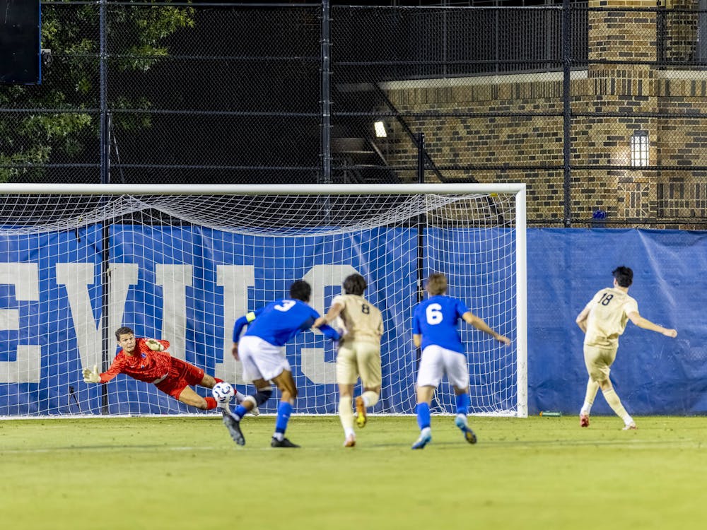 Wessel Speel dives to save Wake Forest's penalty kick. 