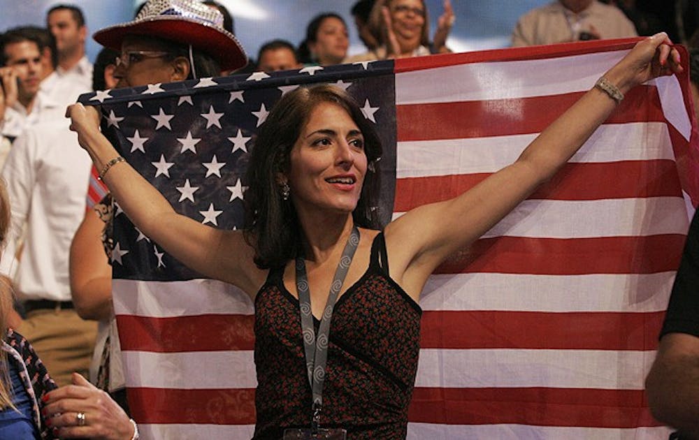 A woman displays an American flag on the floor of the Democratic National Convention in Charlotte Wednesday.