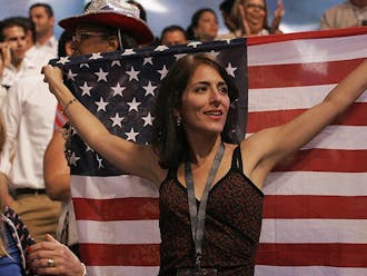 A woman displays an American flag on the floor of the Democratic National Convention in Charlotte Wednesday.