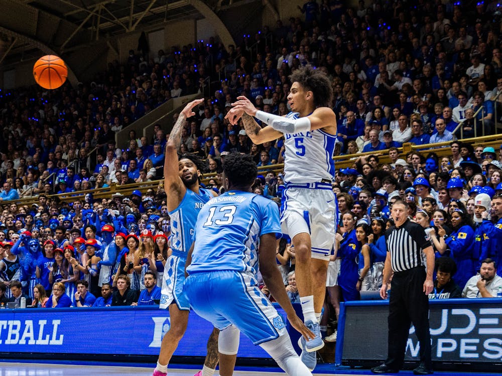 Tyrese Proctor flicks the ball to a teammate during Duke's first half against North Carolina.