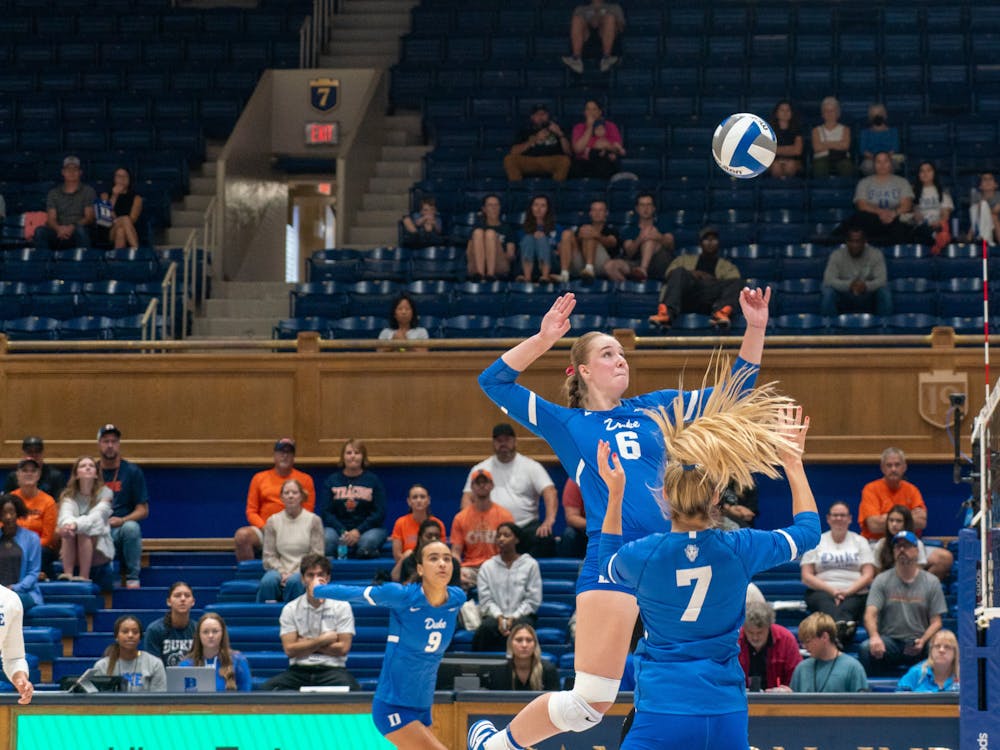 Penn watches as her teammate capitalizes on a perfectly placed set